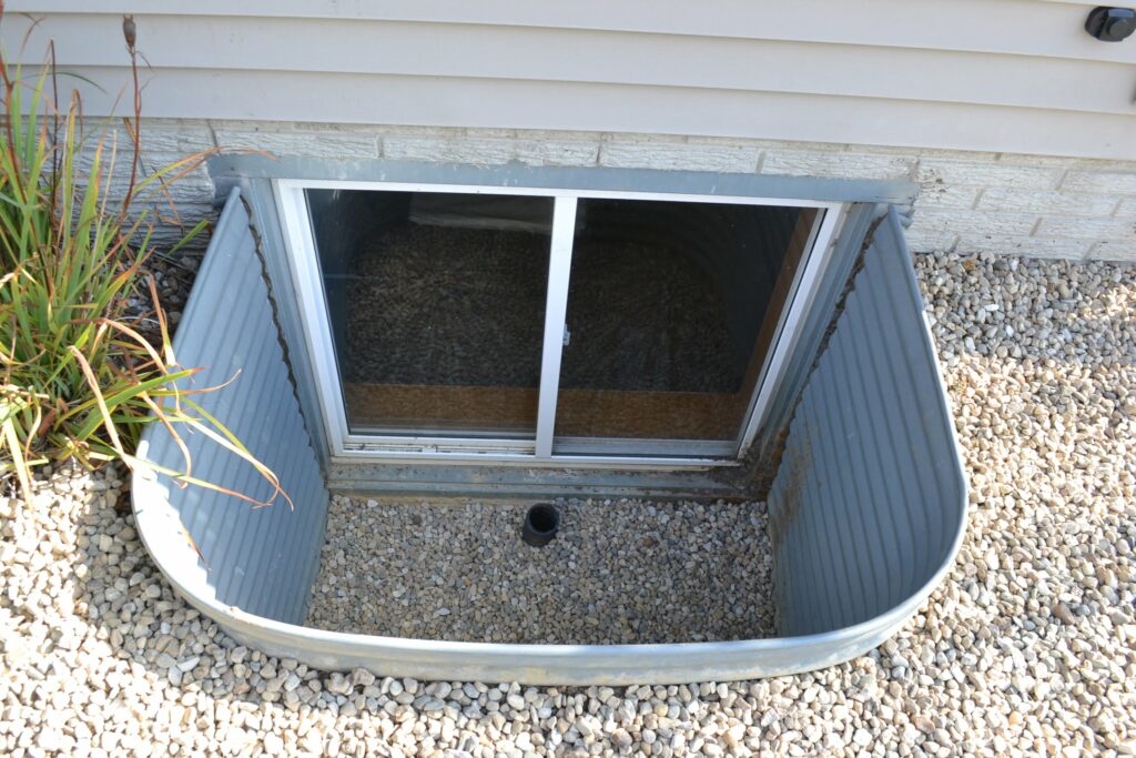 Basement window well drainage installation